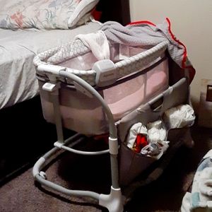 baby bassinet new born- 12 months  has music lights pockets for baby supplies